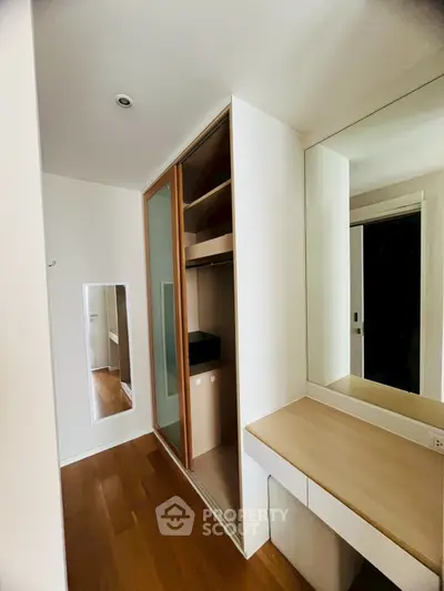 Spacious bedroom with built-in wardrobe and vanity mirror