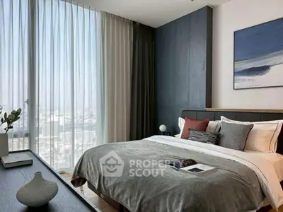 Modern bedroom with large windows and stylish decor, offering a serene city view.