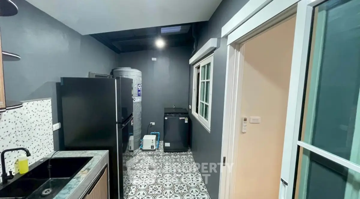 Modern kitchen with sleek appliances and stylish tile flooring