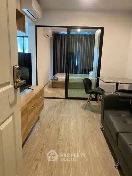 Modern apartment interior with wooden flooring and glass partition