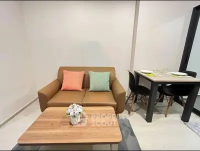 Cozy living room with modern sofa and dining area, perfect for urban living.