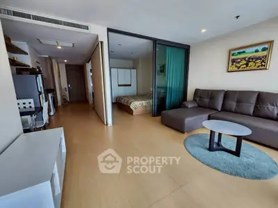 Spacious modern living room with open layout and cozy bedroom view