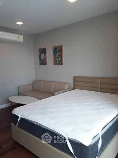 Modern bedroom with stylish decor and comfortable furnishings in a cozy apartment.