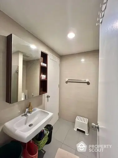 Compact and functional bathroom with well-maintained fixtures, bright lighting, and a clean, neutral color palette.