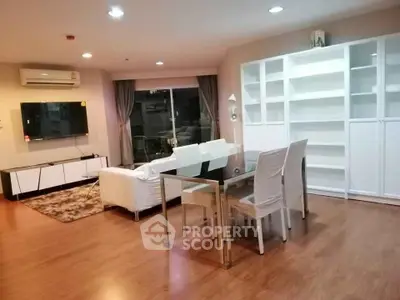 Spacious living room with modern furniture and large window in a stylish apartment.