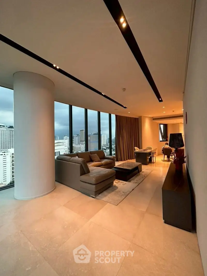 Luxurious high-rise living room with panoramic city views and modern furnishings.