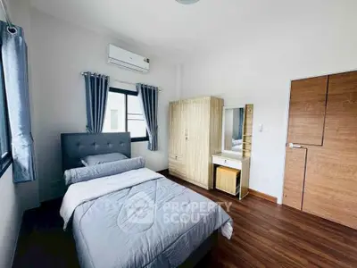 Cozy bedroom with modern furnishings and natural light