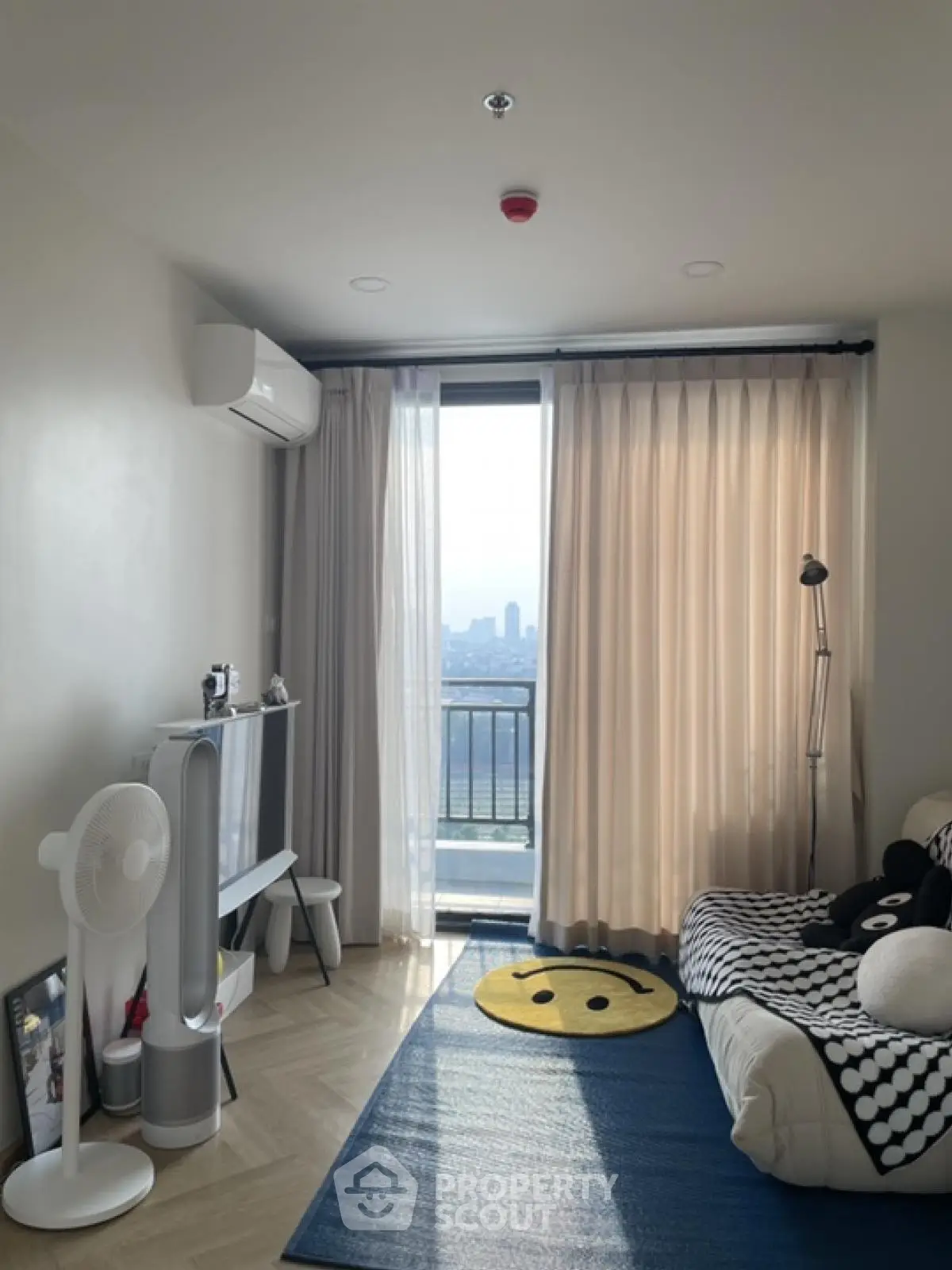 Cozy bedroom with city view, modern decor, and ample natural light