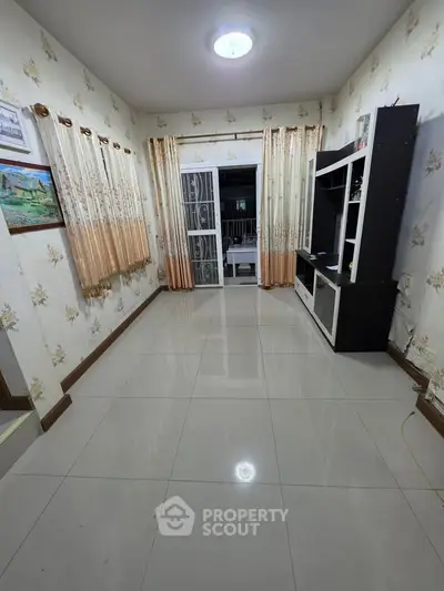 Spacious living room with elegant curtains and modern entertainment unit