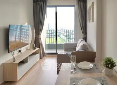 Modern living room with balcony view, stylish decor, and natural light.