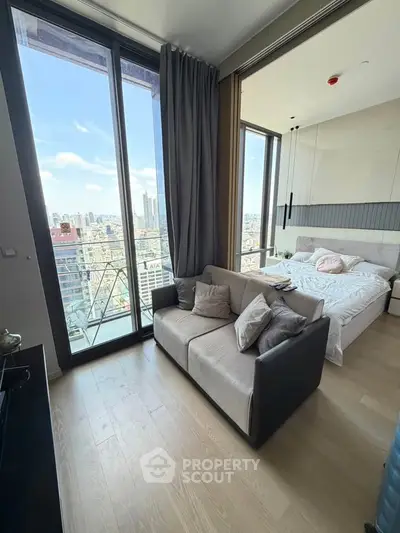 Modern apartment with stunning city view, featuring cozy living area and elegant bedroom.