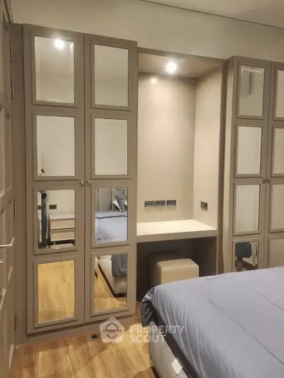 Modern bedroom with mirrored wardrobe and cozy bed setup