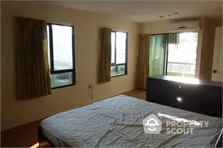 Spacious bedroom with balcony access and natural light