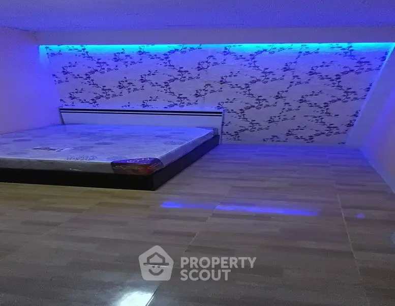Modern bedroom with unique lighting and floral accent wall