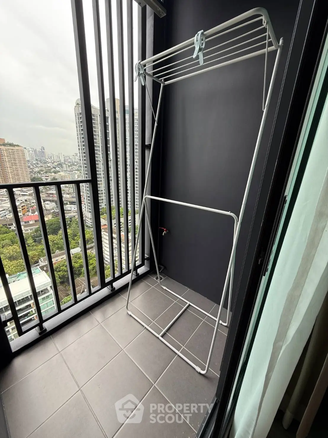 Modern balcony with city view and drying rack, perfect for urban living.