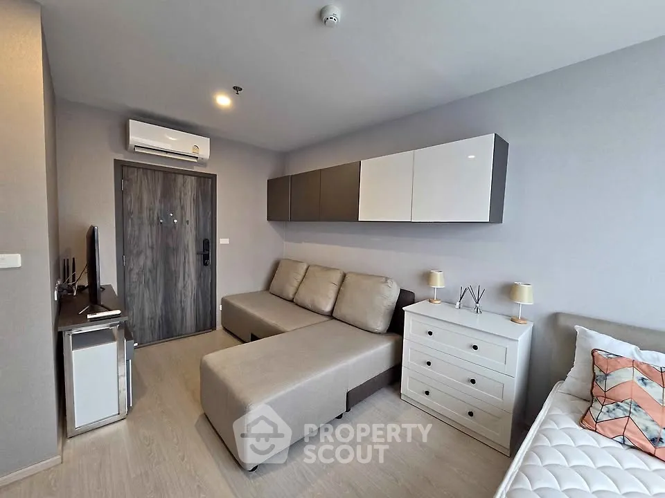 Modern living room with stylish furniture and neutral tones in a cozy apartment setting.
