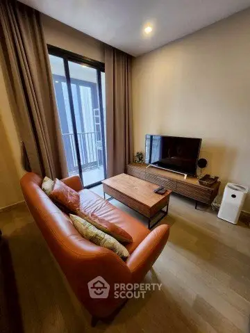 Modern living room with cozy sofa and balcony view in stylish apartment.