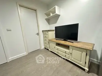Cozy living room corner with TV and elegant wooden furniture