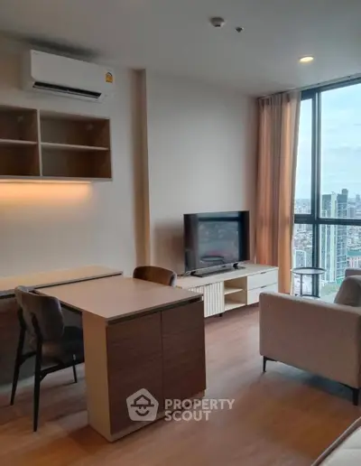Modern living room with city view, featuring sleek furniture and large windows for natural light.
