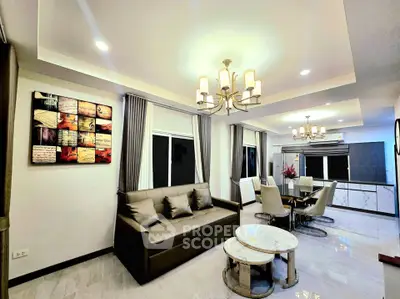 Elegant living room with modern decor and dining area, featuring stylish lighting and comfortable seating.