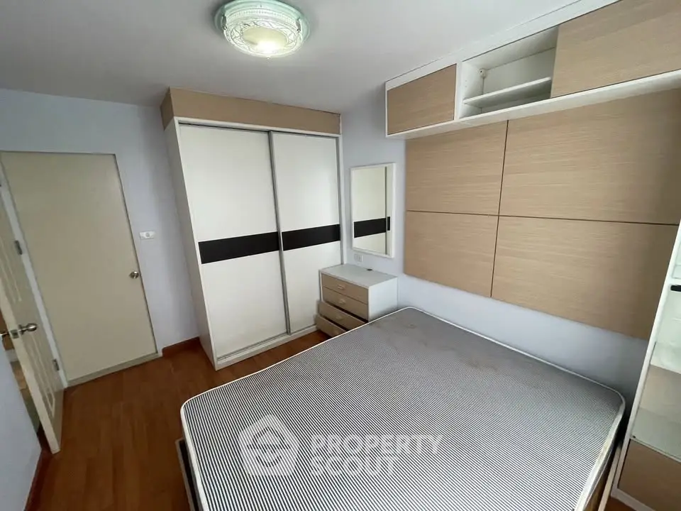 Modern bedroom with sleek wardrobe and minimalist design, perfect for urban living.