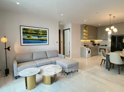 Modern living room with stylish furniture and open kitchen layout in a contemporary apartment.