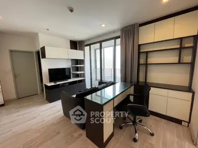 Modern living room with sleek furniture and large windows offering city views.