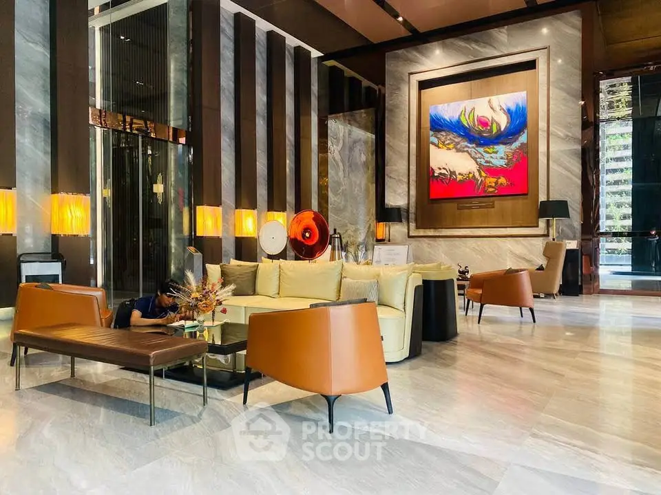 Luxurious modern lobby with elegant seating and contemporary art in a high-end building.