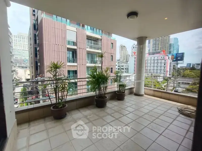Spacious balcony with city view, perfect for urban living and relaxation.