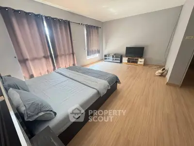 Spacious bedroom with modern decor and natural light