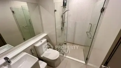Modern bathroom with glass shower and sleek fixtures