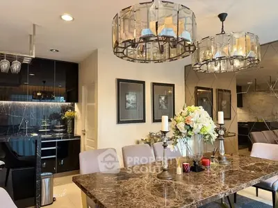 Luxurious dining area with elegant lighting and marble table in modern home.