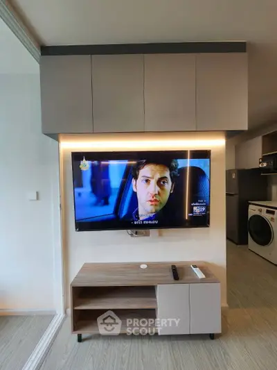 Modern living room with wall-mounted TV and sleek storage unit