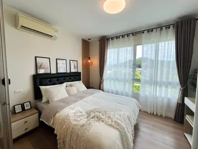 Elegant bedroom with large window and stylish decor, offering a serene and inviting atmosphere.