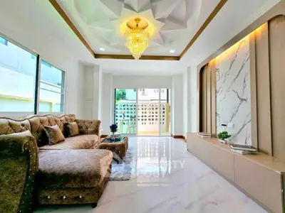 Luxurious living room with elegant chandelier and plush seating in modern home
