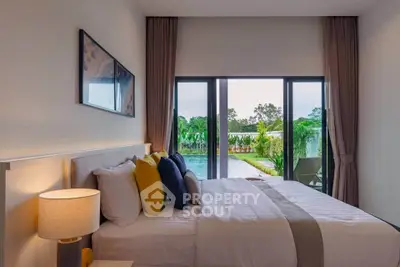Luxurious bedroom with pool view and elegant decor, perfect for relaxation and comfort.