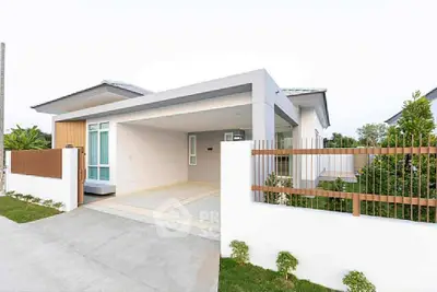 Modern single-story house with sleek design and spacious driveway in a serene neighborhood.
