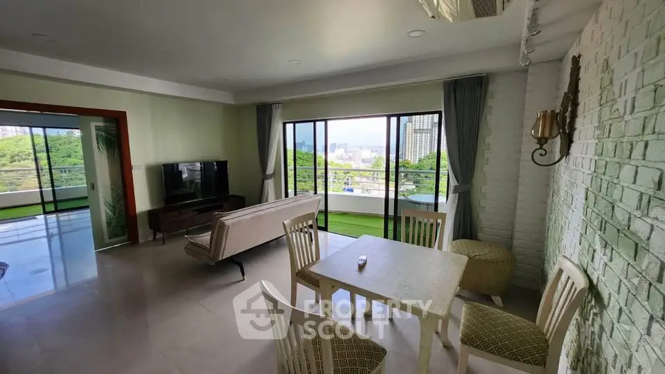 Spacious living room with large balcony and scenic view