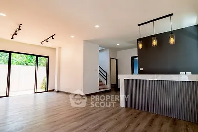 Spacious modern living room with open layout and stylish lighting, perfect for contemporary living.