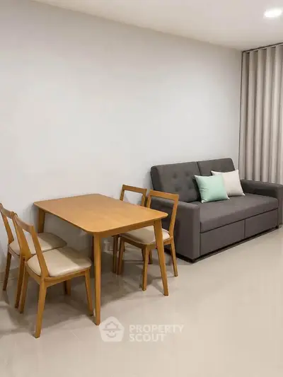 Modern living room with sleek furniture and dining set, perfect for cozy gatherings.