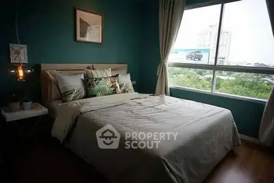 Cozy bedroom with large window offering a scenic view, stylish decor, and comfortable bedding.