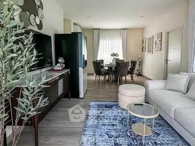 Stylish open-plan living and dining area with modern decor and natural light.