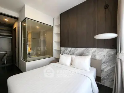 Modern bedroom with stylish decor and large window for natural light.