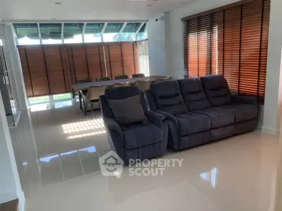 Spacious living room with modern furniture and large windows for natural light.