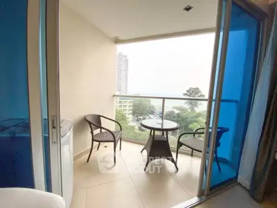 Charming balcony with seating and scenic view, perfect for relaxation.