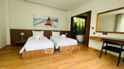Spacious modern bedroom with twin beds and elegant decor in a luxury property.