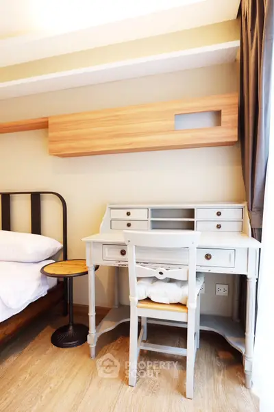 Charming bedroom with vintage desk and modern decor, perfect for a cozy and stylish living space.