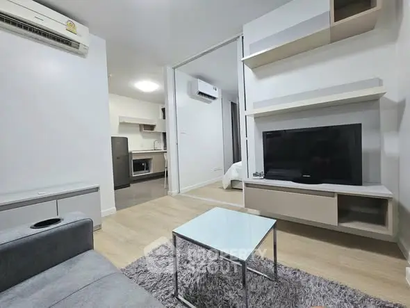 Modern living room with sleek furniture and open kitchen layout