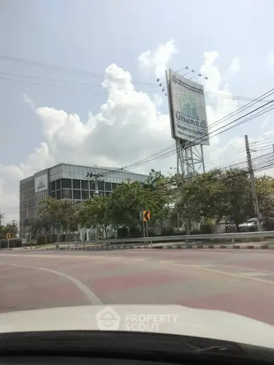 Modern commercial building with large billboard in urban setting, ideal for business opportunities.