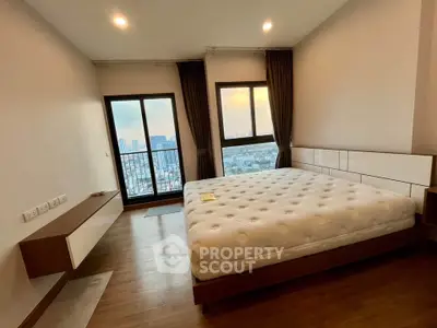 Spacious bedroom with city view and modern furnishings